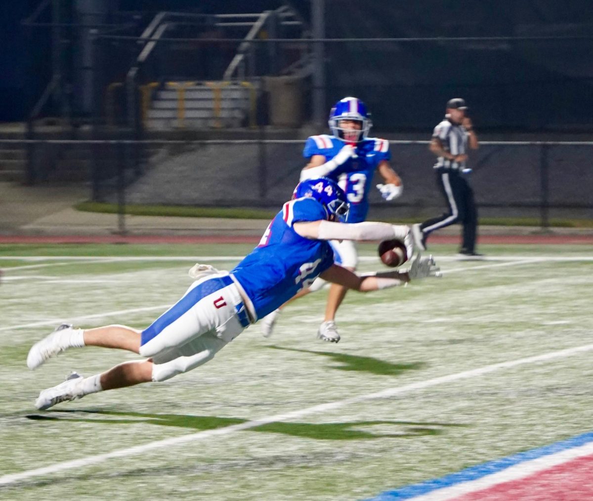 Junior Foster Flaherty outstretches his arms and dives into the end zone against Kirby.