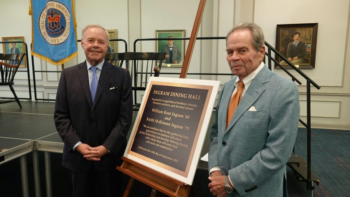 Kent and Keith Ingram stand by their plaque for the dedication of the Ingram Dining Hall