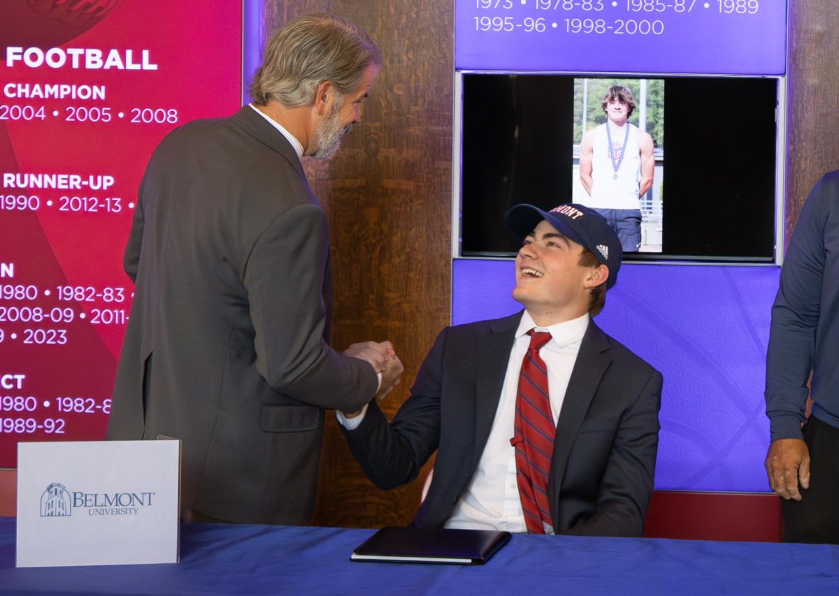 BEAR TRACKS: McEwen Taylor (12) and his coach, Drew Hinote, dap each other up on his signing day to join the Belmont University Bruins.