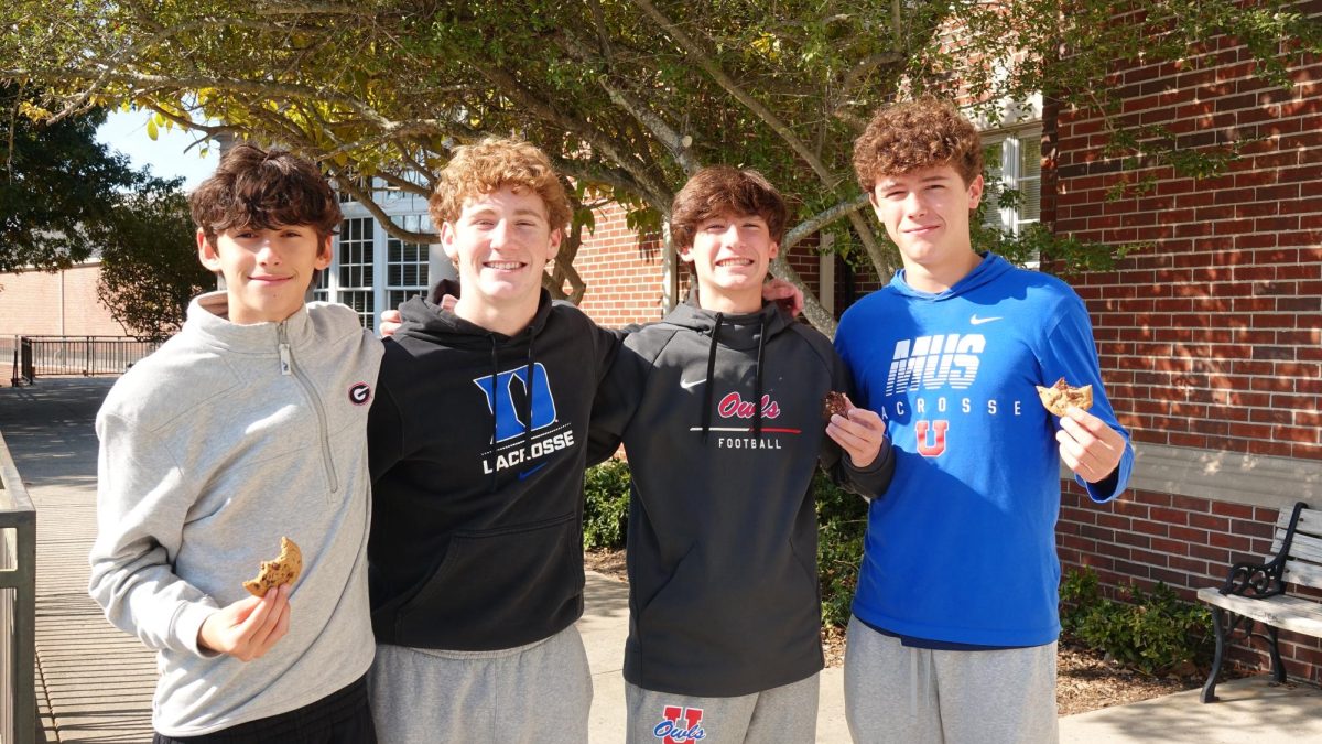 Freshmen pose with treats following their Dean's Cup victory after the conclusion of the first quarter.